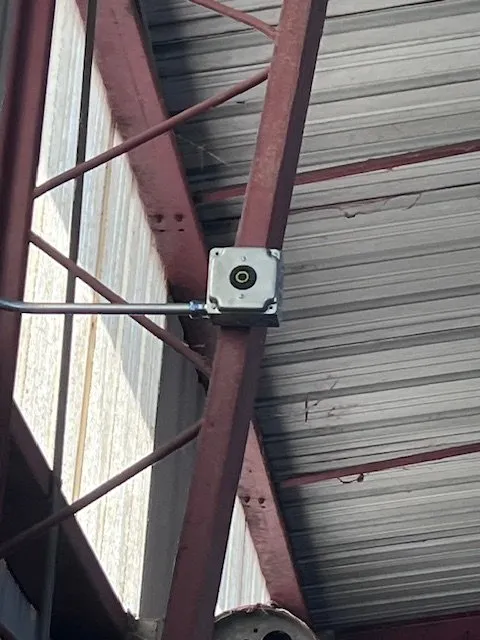 A new outlet box mounted on a red steel beam