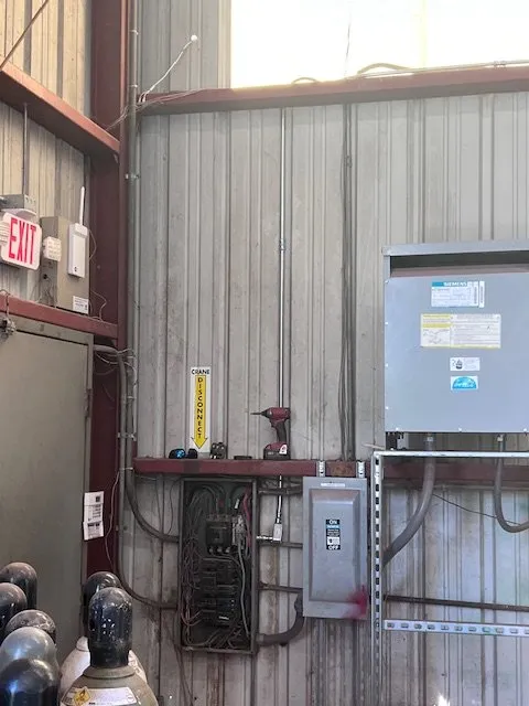 Electrical panels and a disconnect on the wall of the shop